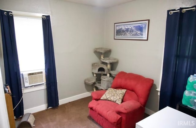 sitting room featuring plenty of natural light, carpet floors, and cooling unit