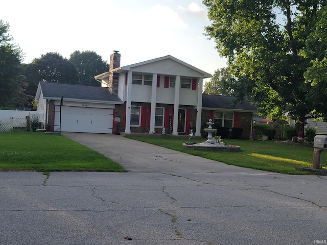 neoclassical / greek revival house with a garage and a front yard