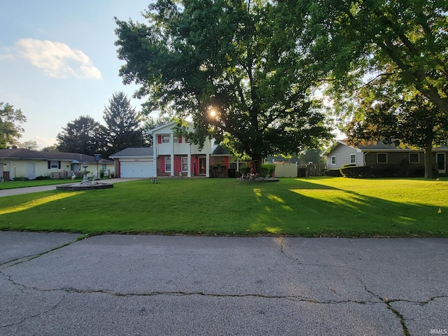 view of front of property featuring a garage and a front yard