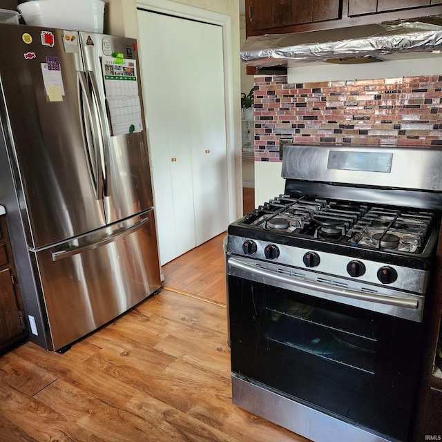 kitchen with backsplash, light hardwood / wood-style floors, dark brown cabinetry, and stainless steel appliances