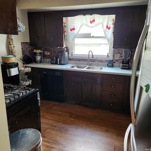 kitchen featuring decorative backsplash, dark hardwood / wood-style floors, sink, stainless steel fridge with ice dispenser, and black dishwasher