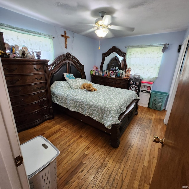 bedroom with hardwood / wood-style floors and ceiling fan