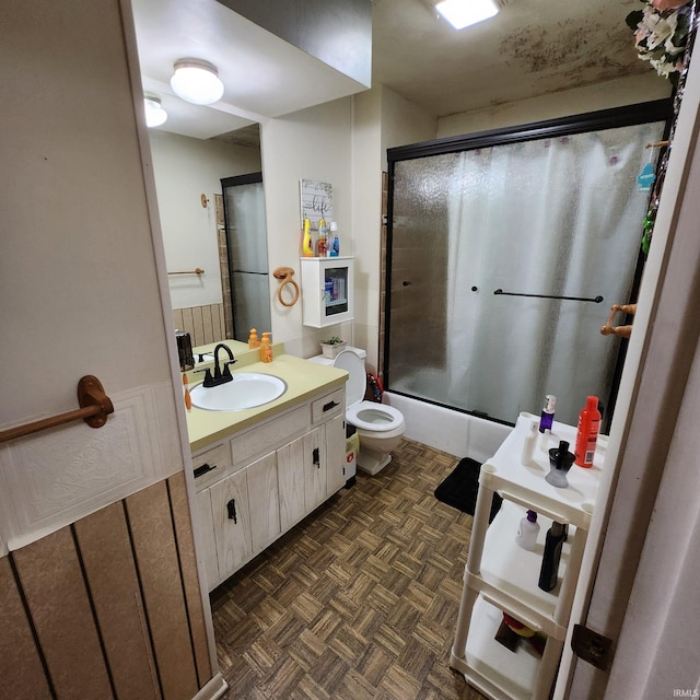 bathroom with toilet, vanity, and parquet flooring