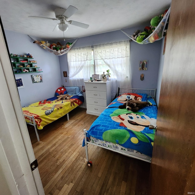 bedroom with ceiling fan and wood-type flooring