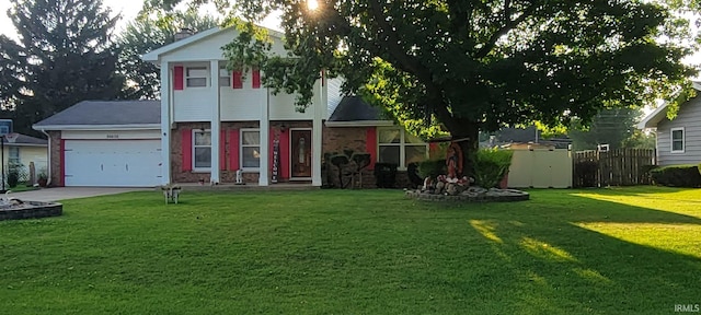 view of front of home with a front yard and a garage