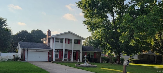 view of front of home with a front yard and a garage