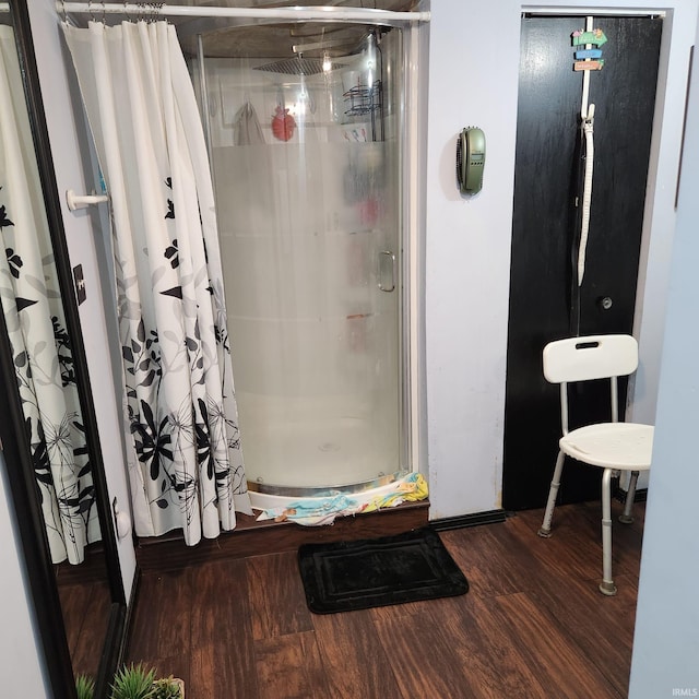 bathroom with a shower with curtain and wood-type flooring