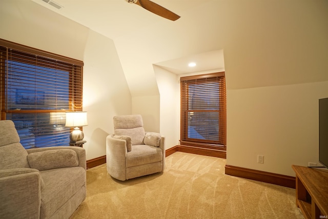 sitting room featuring light carpet, ceiling fan, lofted ceiling, and baseboards