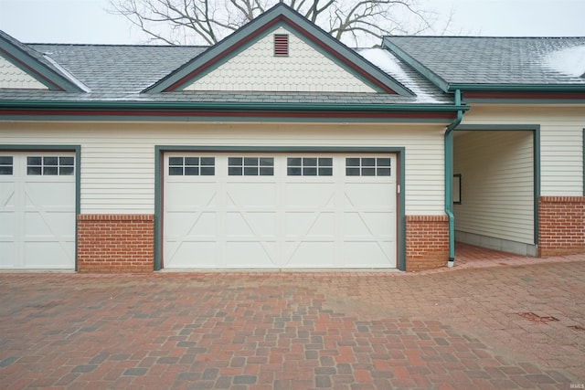 garage featuring decorative driveway