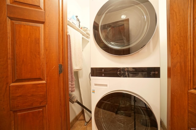 washroom with stacked washing maching and dryer and laundry area