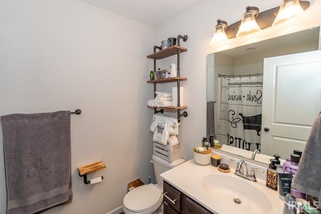 bathroom with toilet and vanity