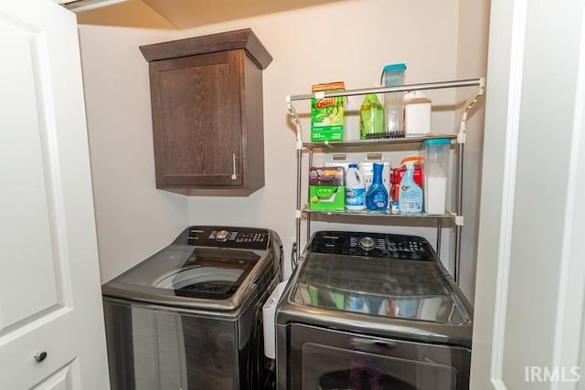 laundry room featuring washing machine and dryer and cabinets