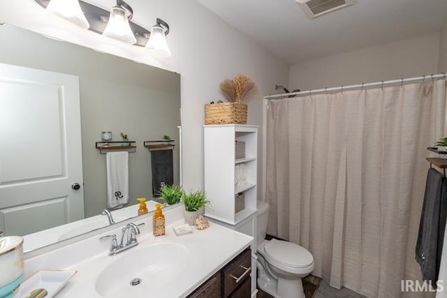 bathroom featuring toilet and vanity