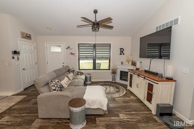 living room featuring ceiling fan, dark hardwood / wood-style flooring, and lofted ceiling