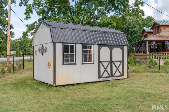 view of outdoor structure featuring a lawn