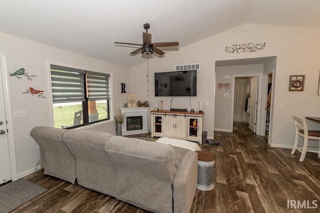 living room featuring ceiling fan, dark hardwood / wood-style floors, and lofted ceiling