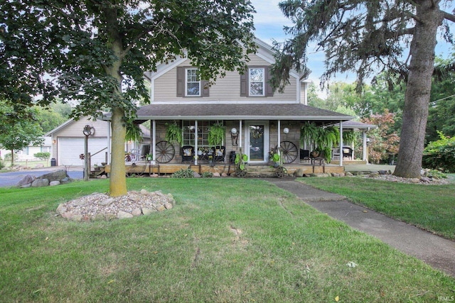 farmhouse inspired home with covered porch, a garage, and a front lawn