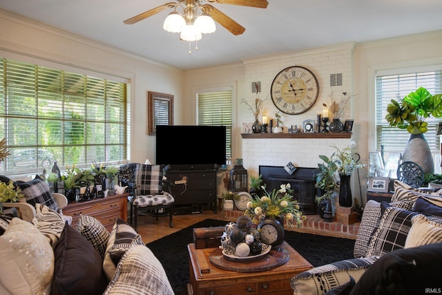 living room with a fireplace, brick wall, ceiling fan, and wood-type flooring