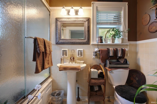 bathroom featuring backsplash, toilet, and tile walls