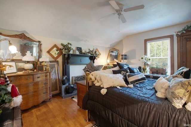 bedroom featuring ceiling fan, vaulted ceiling, and hardwood / wood-style flooring