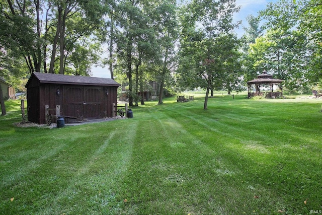 view of yard with a gazebo and a shed