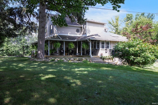 rear view of property with a yard