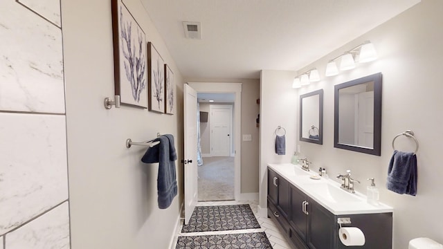 bathroom featuring tile patterned flooring and double sink vanity