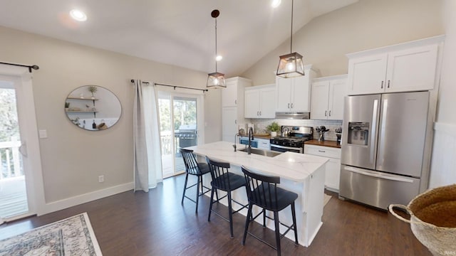 kitchen featuring sink, tasteful backsplash, appliances with stainless steel finishes, and dark hardwood / wood-style floors