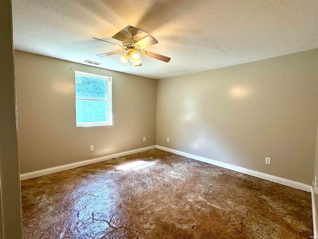 tiled empty room featuring ceiling fan and a textured ceiling