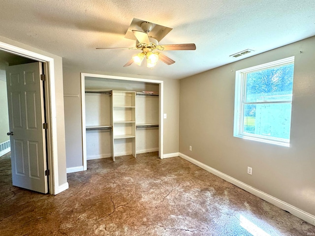 unfurnished bedroom featuring a textured ceiling, a closet, ceiling fan, and tile patterned floors