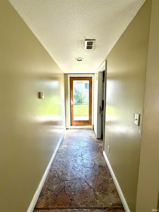 hallway with a textured ceiling