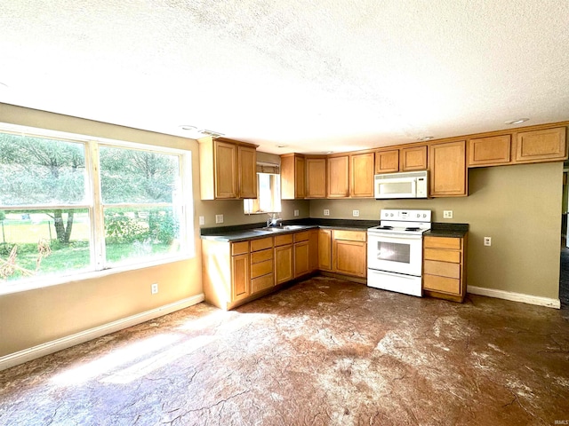 kitchen featuring sink, a textured ceiling, and white appliances