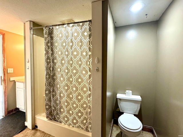 bathroom with a textured ceiling, tile patterned flooring, vanity, toilet, and walk in shower