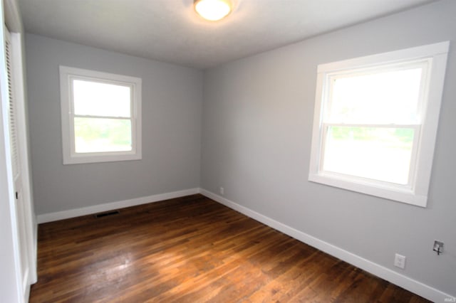 unfurnished room featuring dark hardwood / wood-style floors