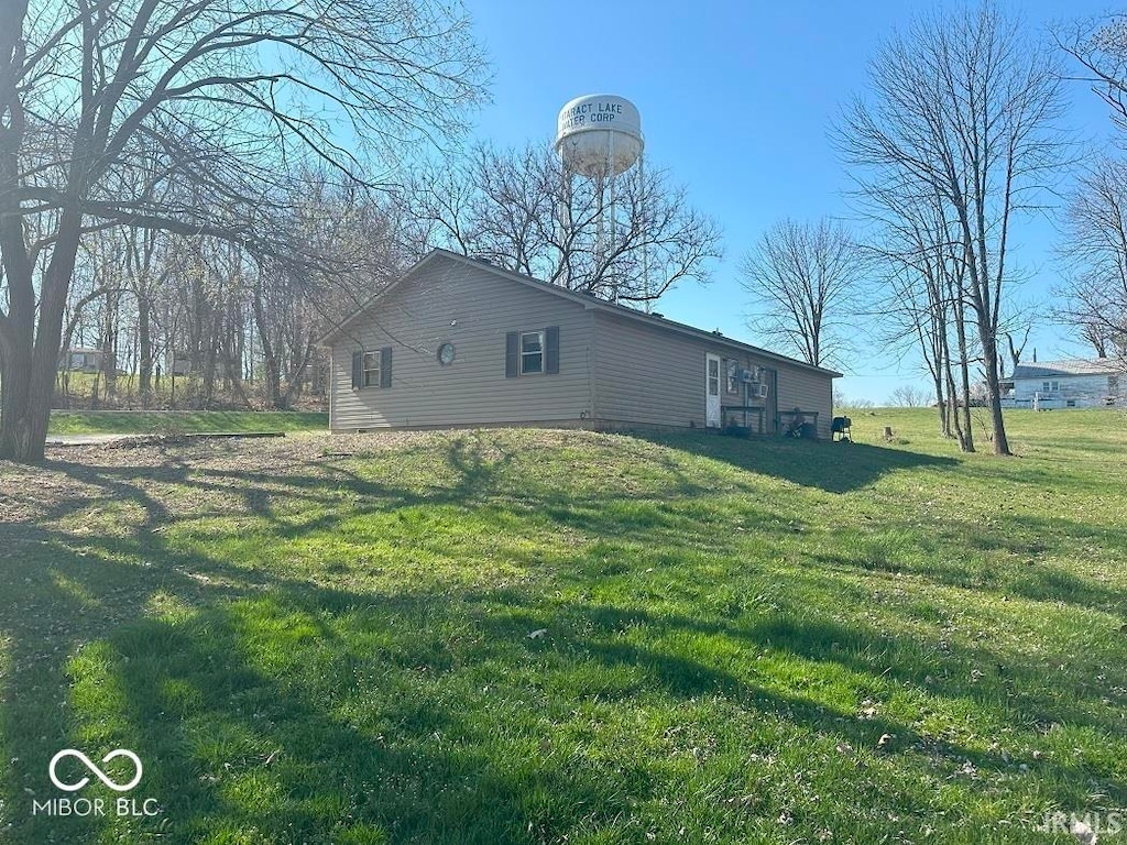 view of property exterior featuring a lawn