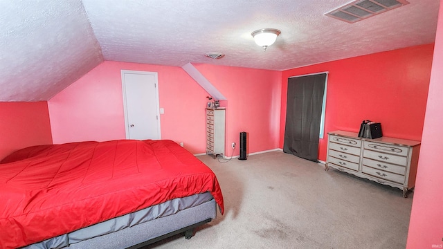 bedroom with light colored carpet, a textured ceiling, and lofted ceiling