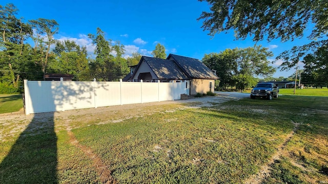 view of side of property with a yard