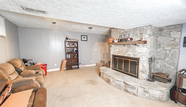 living room featuring carpet, a textured ceiling, and a fireplace