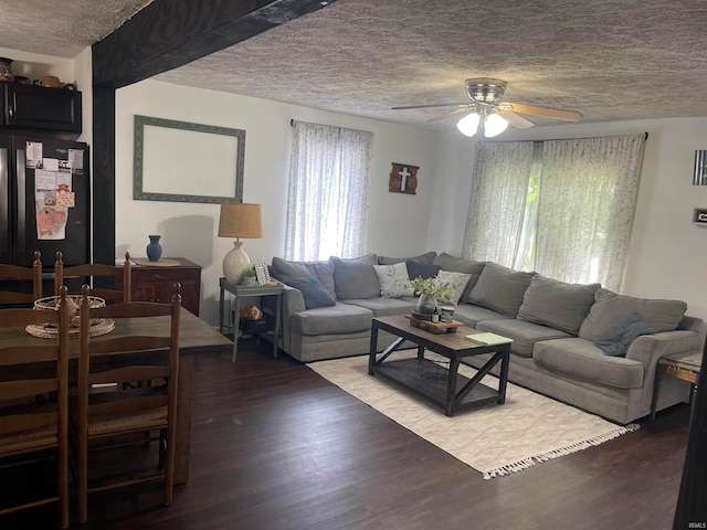 living room with a textured ceiling, light hardwood / wood-style flooring, and ceiling fan