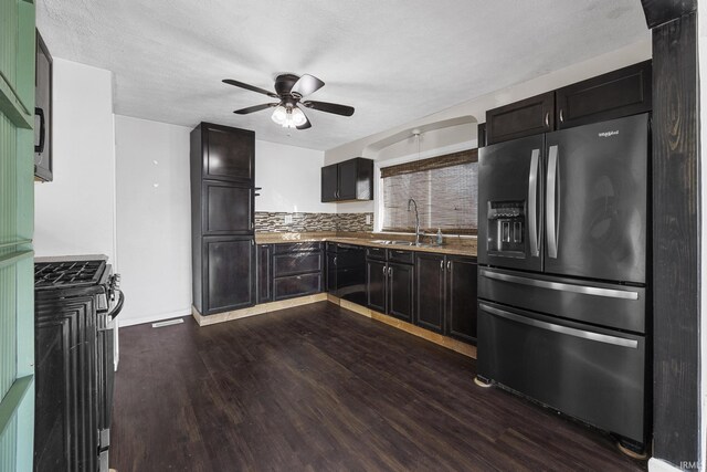 dining room with dark hardwood / wood-style flooring, sink, ceiling fan, and a textured ceiling