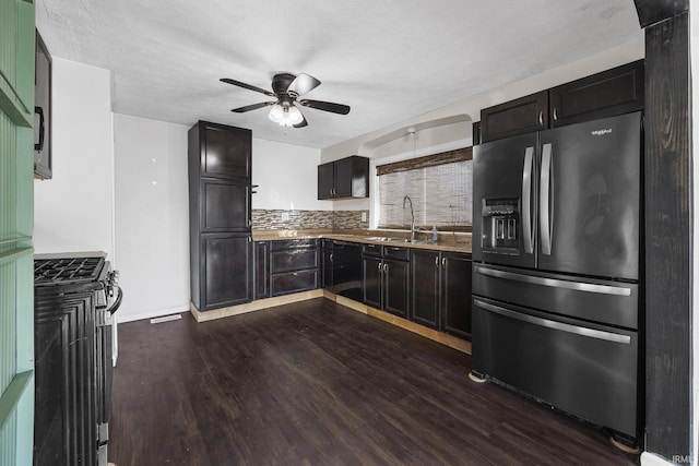 kitchen with a sink, stainless steel fridge, a ceiling fan, and dark wood-type flooring