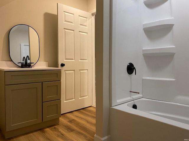 bathroom featuring bathtub / shower combination, wood-type flooring, and vanity