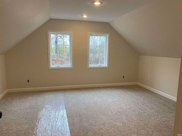 bonus room featuring carpet flooring and vaulted ceiling