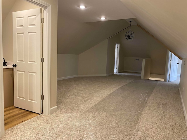 additional living space featuring light carpet and lofted ceiling