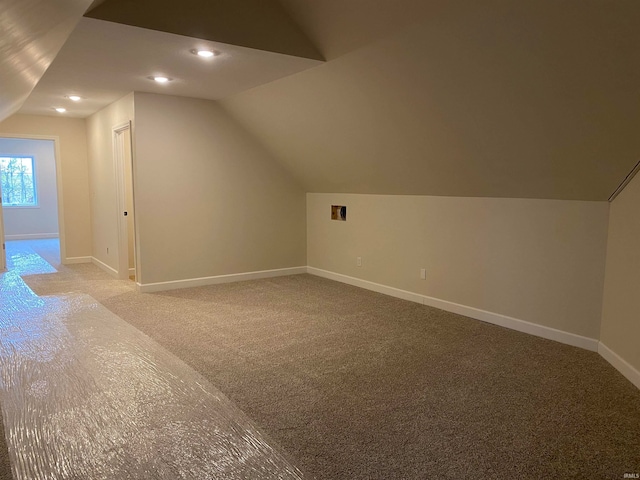 bonus room featuring carpet and vaulted ceiling