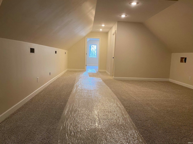 bonus room featuring carpet and vaulted ceiling