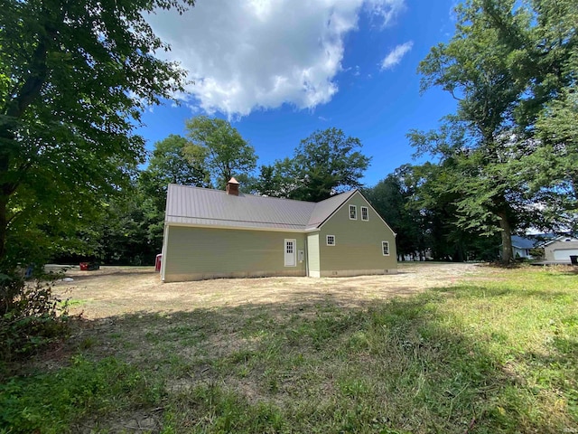 view of property exterior featuring a lawn