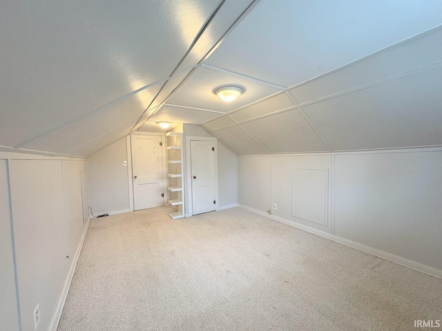 bonus room featuring vaulted ceiling, baseboards, and carpet floors