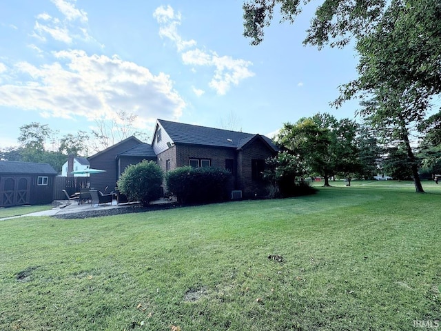 exterior space featuring an outdoor structure, a storage unit, and a patio