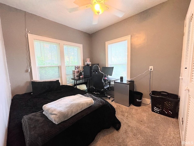 bedroom with ceiling fan, a closet, and carpet